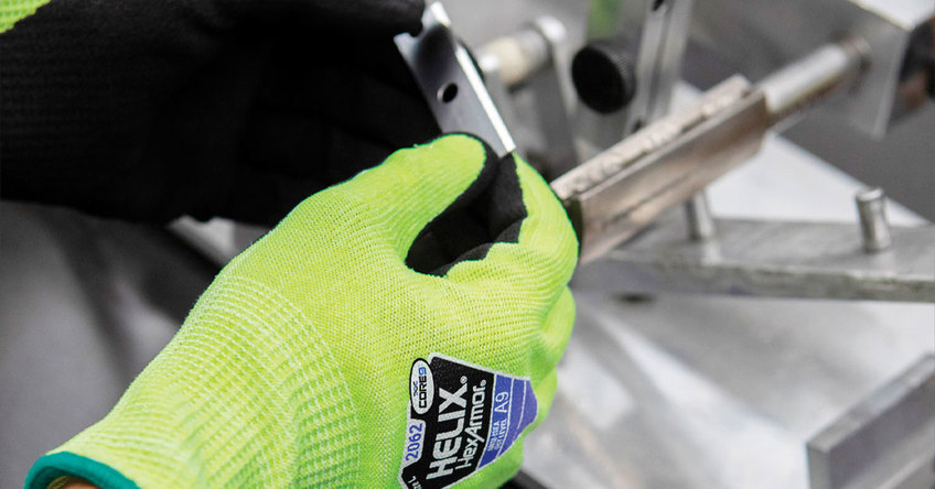 Hands wearing Helix 2062 cut-resistant gloves holding razors.