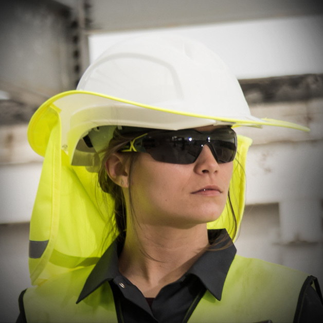 Construction worker wearing safety helmet shade and UV blocking safety glasses.