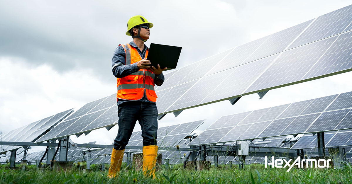 Man standing on a solar field wearing HexArmor PPE. 