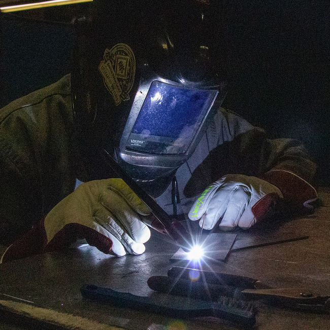Welder wearing the HeatArmor 5058 cut-resistant welding gloves using a TIG welding torch.