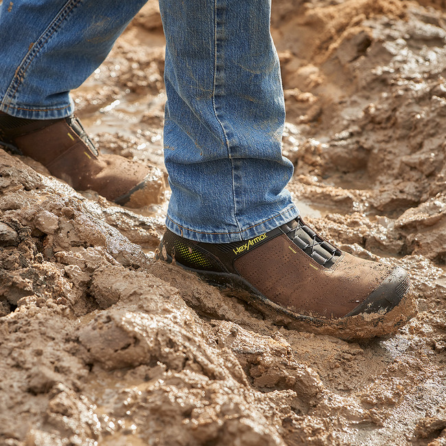 Worker standing in Xbase BOA composite toe work boots on construction site.