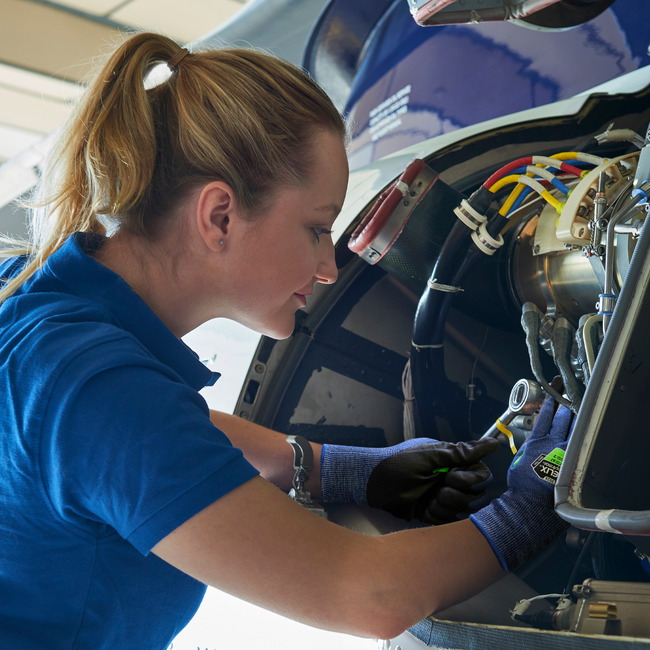Aerospace workers working on a helicopter wearing the Helix 3026 cut-resistant gloves. 