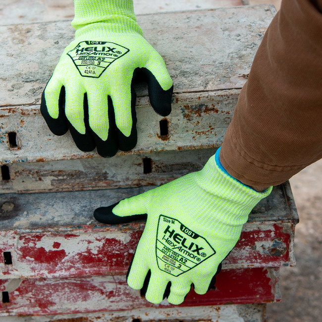 Hands wearing the Helix 1081 while working on concrete slabs.