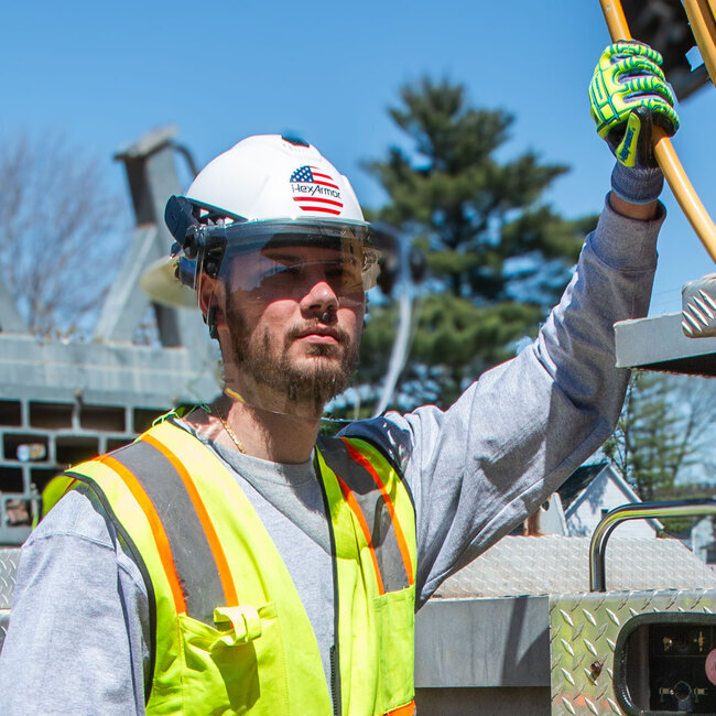 TruSpan® universal face shield in the active position on our full brim helmet worn by a construction worker