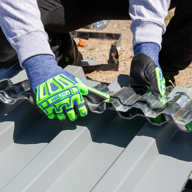 Worker hands wearing Helix 3026IMP impact gloves grasping a large chain on the job.