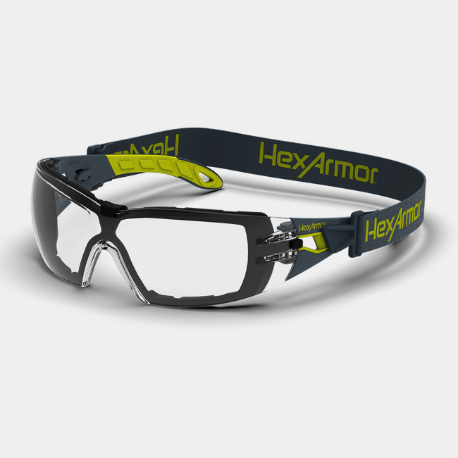 Grey and yellow MX200G anti-fog safety spoggles with head strap and foam gaskets shown as they are sitting on a table.