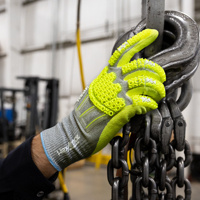 Worker wearing the Helix 3014IMP impact gloves while working on a machine.
