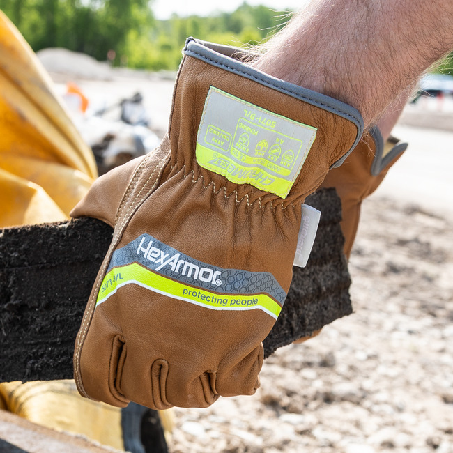 Hands wearing chrome slt 5072 padded palm work gloves with sustainable leather treatment.