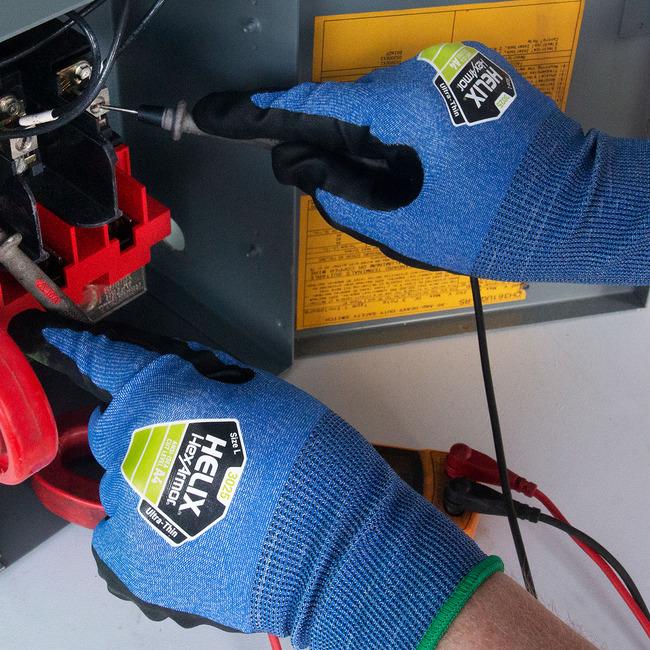 Hands wearing the blue Helix 3025 high-dexterity work gloves while doing electrical work.