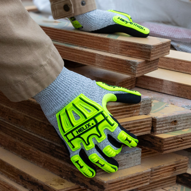 Worker wearing the Helix 1075IMP impact gloves while working with wood.