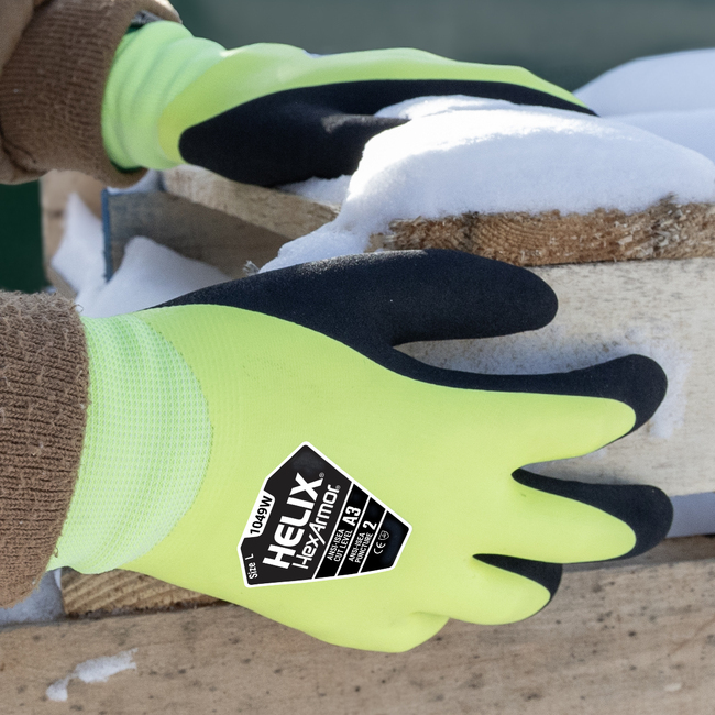 A worker wearing the Helix 1049W winter work gloves while working in the snow. 