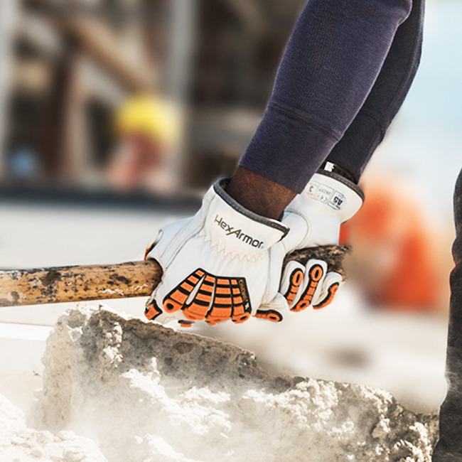 Worker wearing the Chrome SLT 4060 safety gloves holding a sledge hammer.