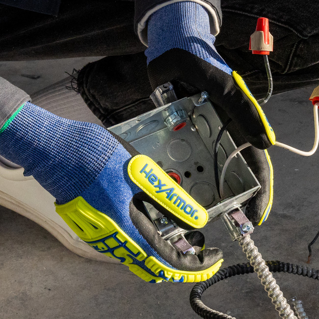Hands wearing the 3015 Helix abrasion-resistant gloves while holding a metal box.