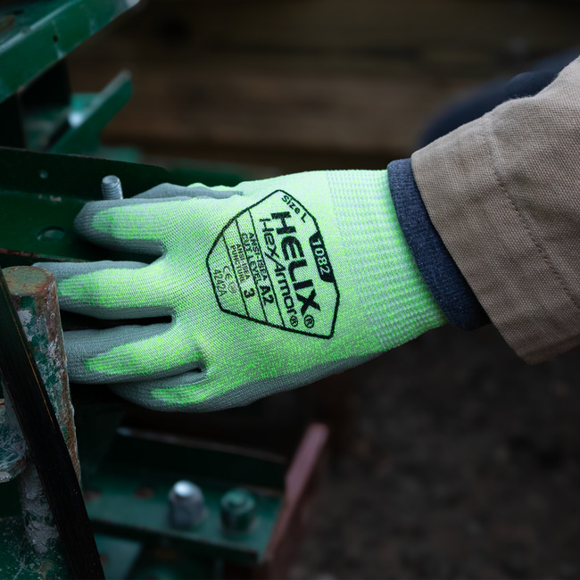 Hand wearing Helix 1082 general purpose work glove handling small tools and materials with ease.