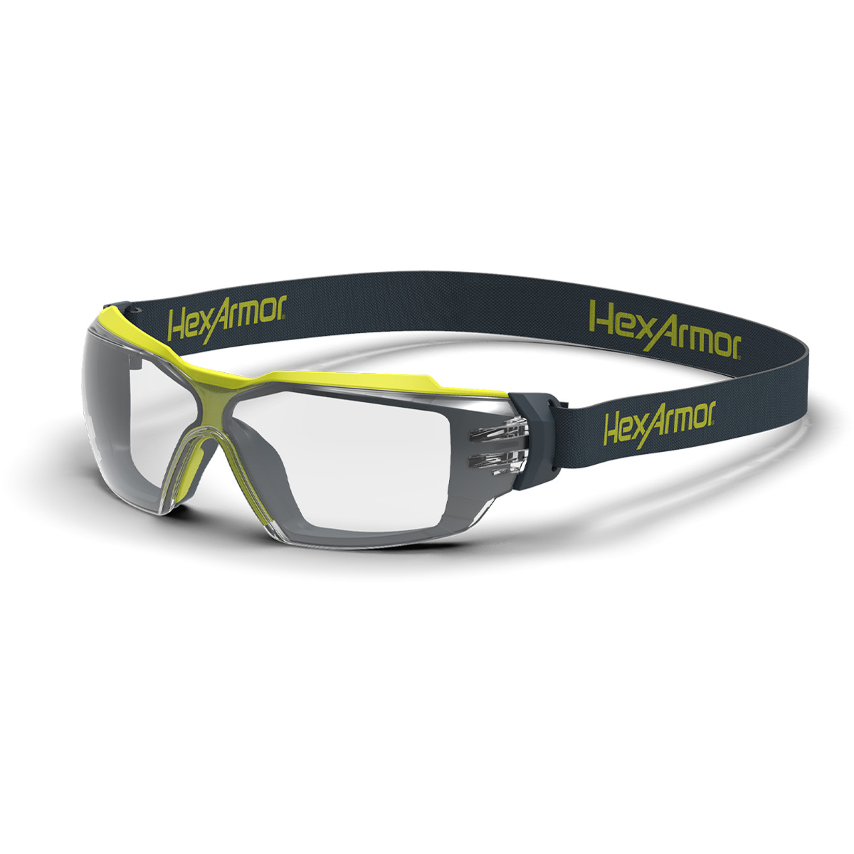 Grey and yellow MX350 anti-fog safety glasses with head strap shown as they are sitting on a table.